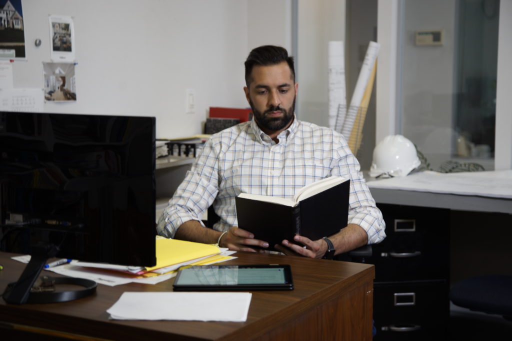 online program student reading book on break at work