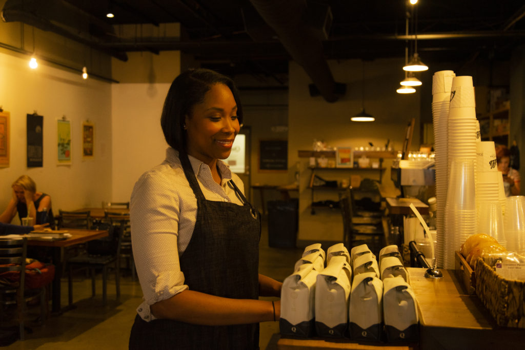 military woman working in coffee shop about online program